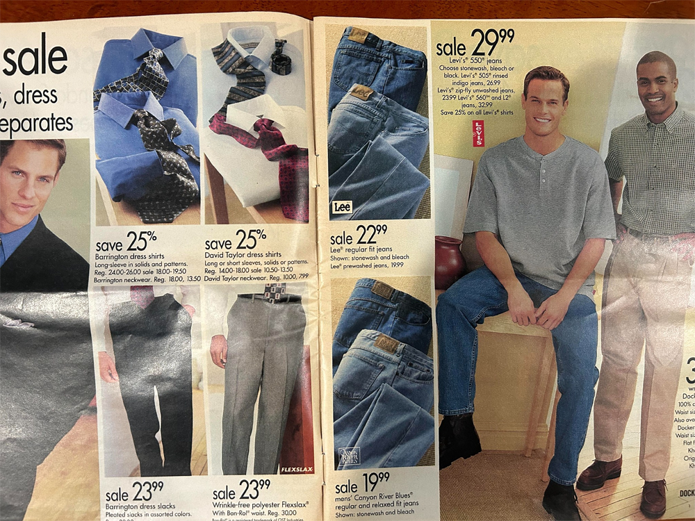 Two catalog pages show men’s clothing, including ties, dress shirts, dress pants, jeans, and casual shirts, with sale prices and photos of male models wearing or displaying the clothes.