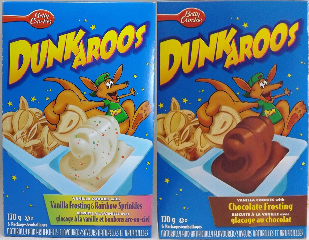 Two Dunkaroos boxes: one with vanilla frosting and rainbow sprinkles, the other with chocolate frosting. Each shows a kangaroo mascot and vanilla cookies being dipped in frosting. Both boxes are blue with colorful branding.