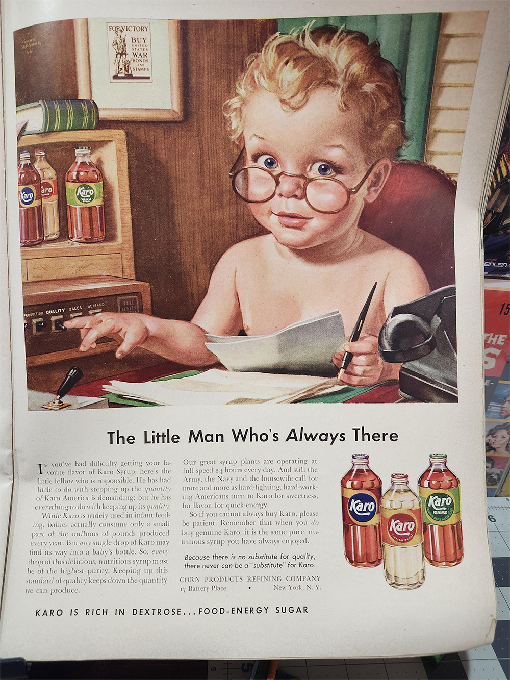 A vintage ad shows a young boy with glasses at a desk, holding a pen and paper, with jars of Karo syrup nearby. He looks up seriously. The ad text below describes Karo syrup.