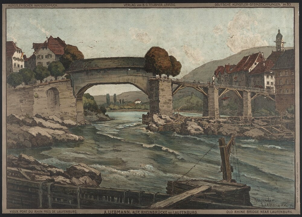 A stone and wooden bridge spans a river with rocky banks, connecting two towns with traditional European buildings and trees, set against rolling hills under a cloudy sky.
