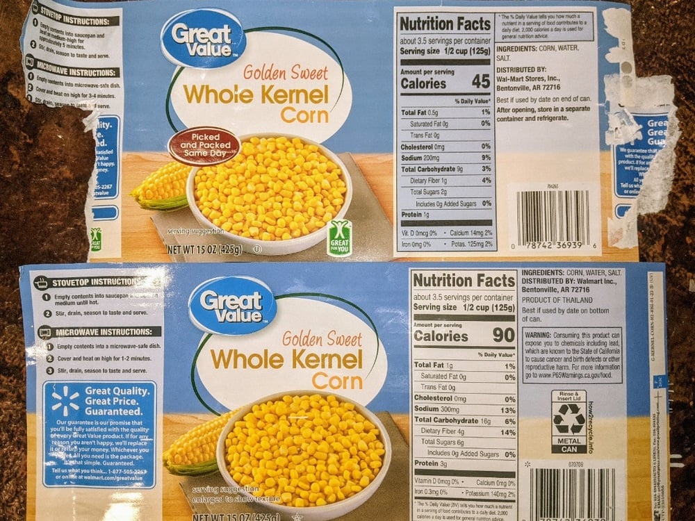 Two Great Value Whole Kernel Corn cans with nutrition facts, ingredients, cooking instructions, and a bowl of corn on the labels are placed on a brown textured surface.