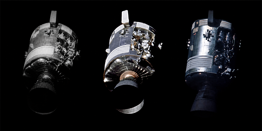 Three side-by-side views of a damaged spacecraft module floating in space, shown against a black background. The module’s outer shell appears broken with internal components exposed.