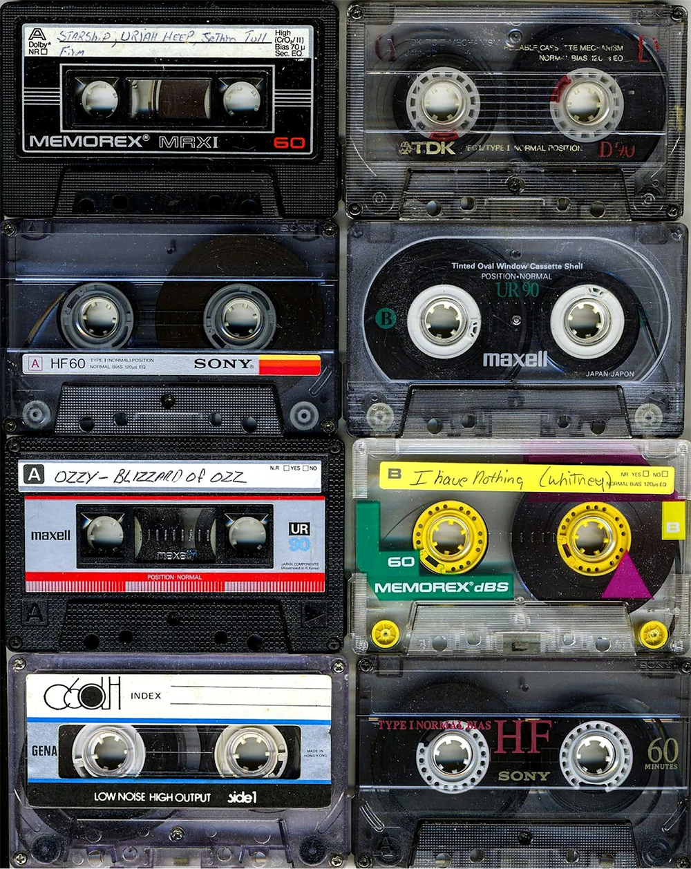A collage of nine vintage cassette tapes from brands like Memorex, TDK, Sony, and Maxell, some labeled with handwritten titles, arranged in a 3x3 grid.