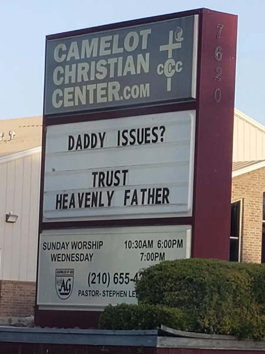 A church sign reads: “DADDY ISSUES? TRUST HEAVENLY FATHER.” Below, it lists worship times, the church’s website, address number, and contact information.