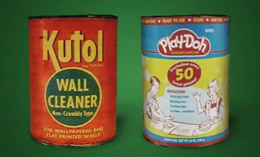 Two vintage cans: one labeled “Kutol Wall Cleaner,” the other “Play-Doh.” Both have colorful designs and retro fonts. The Kutol can is red-orange; the Play-Doh can is blue and yellow with illustrations of children.