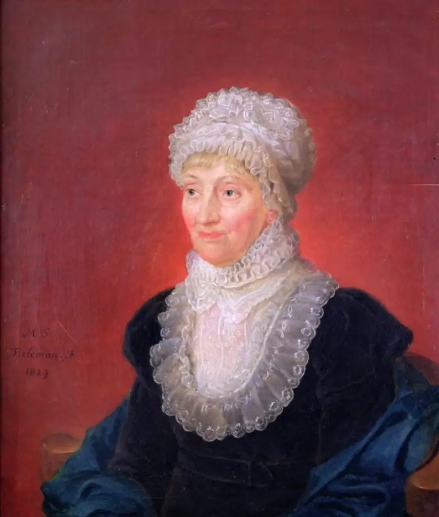 An elderly woman in a white lace bonnet and ruffled collar poses for a painted portrait against a red background, wearing a dark dress and sitting on a chair.