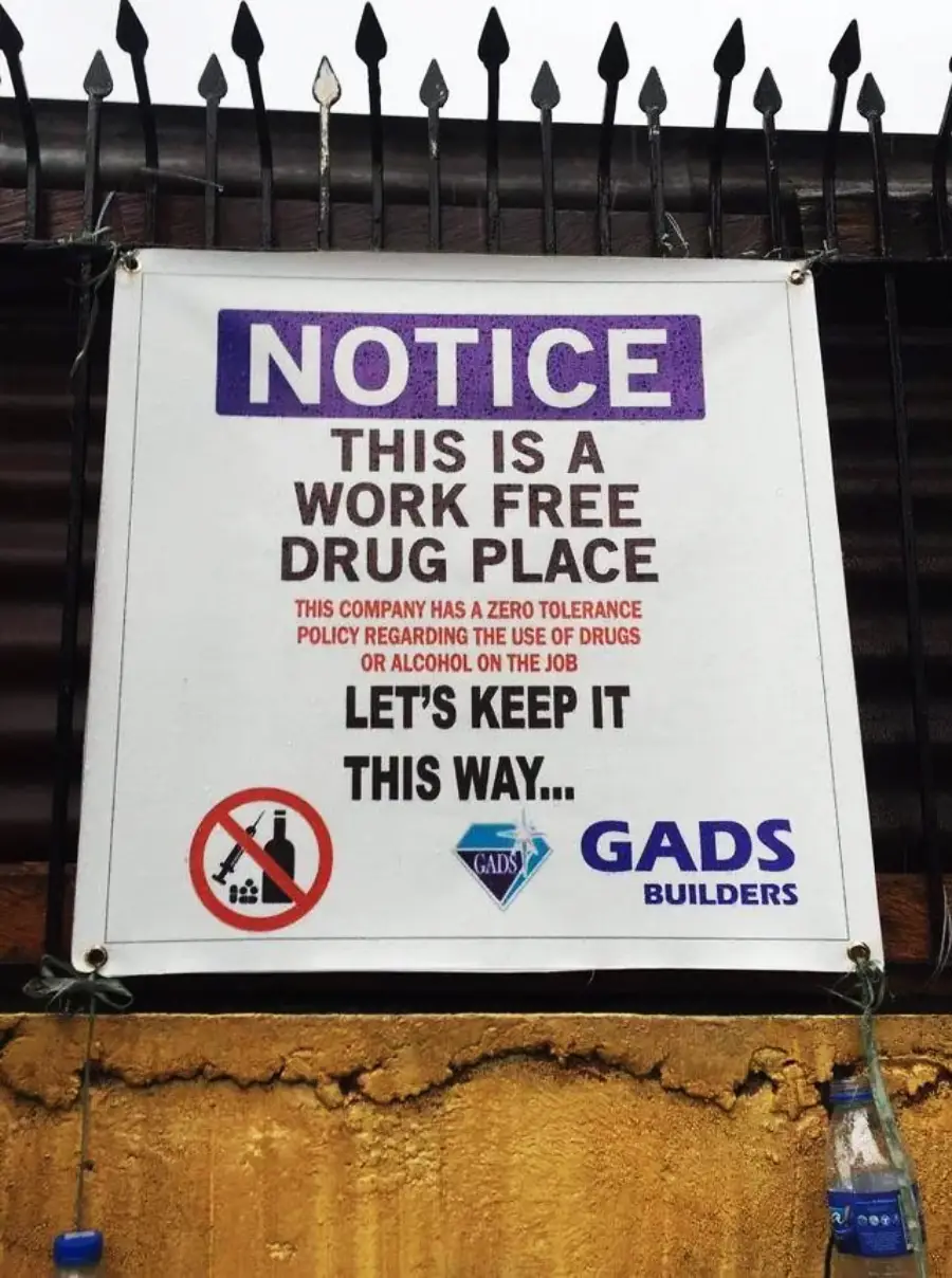 A sign reads: “NOTICE: This is a work free drug place. This company has a zero tolerance policy regarding the use of drugs or alcohol on the job. Let’s keep it this way. GADS Builders.”
