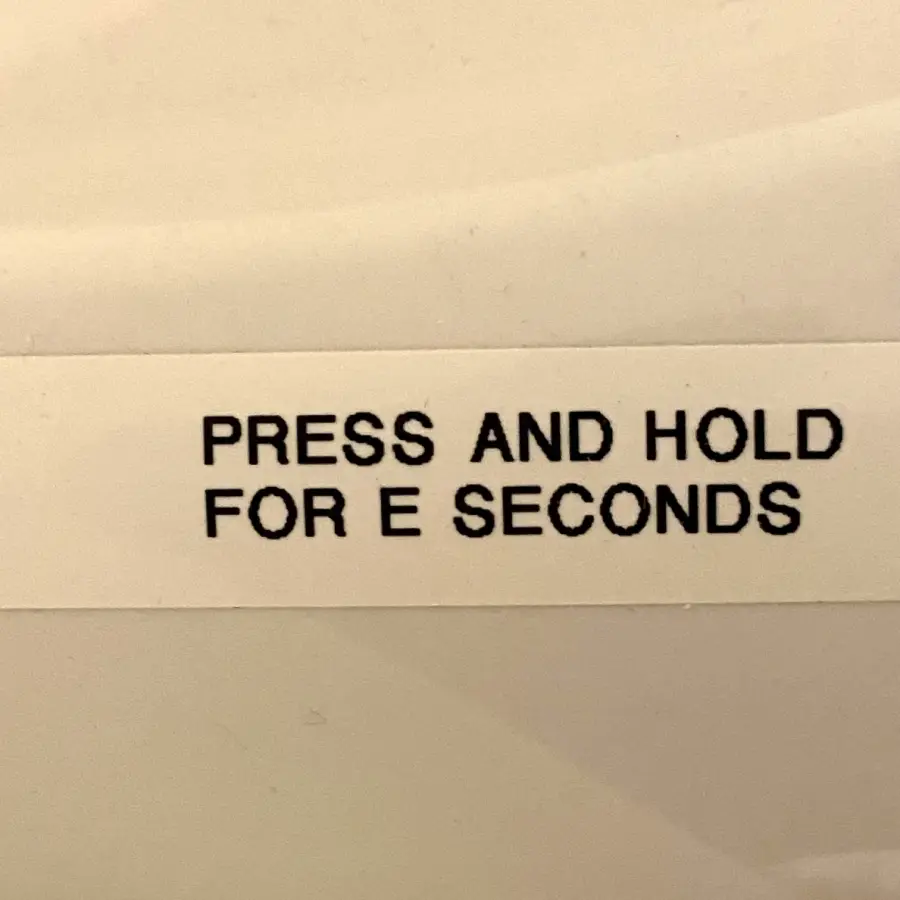 A label reads “PRESS AND HOLD FOR E SECONDS” with the “E” misaligned, making it unclear how many seconds are needed.