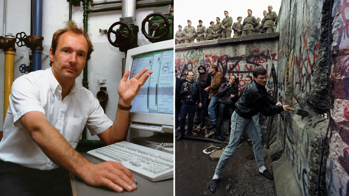 A man sits at a computer with pipes in the background; beside him, people chip away at a graffiti-covered concrete wall as soldiers and onlookers watch.