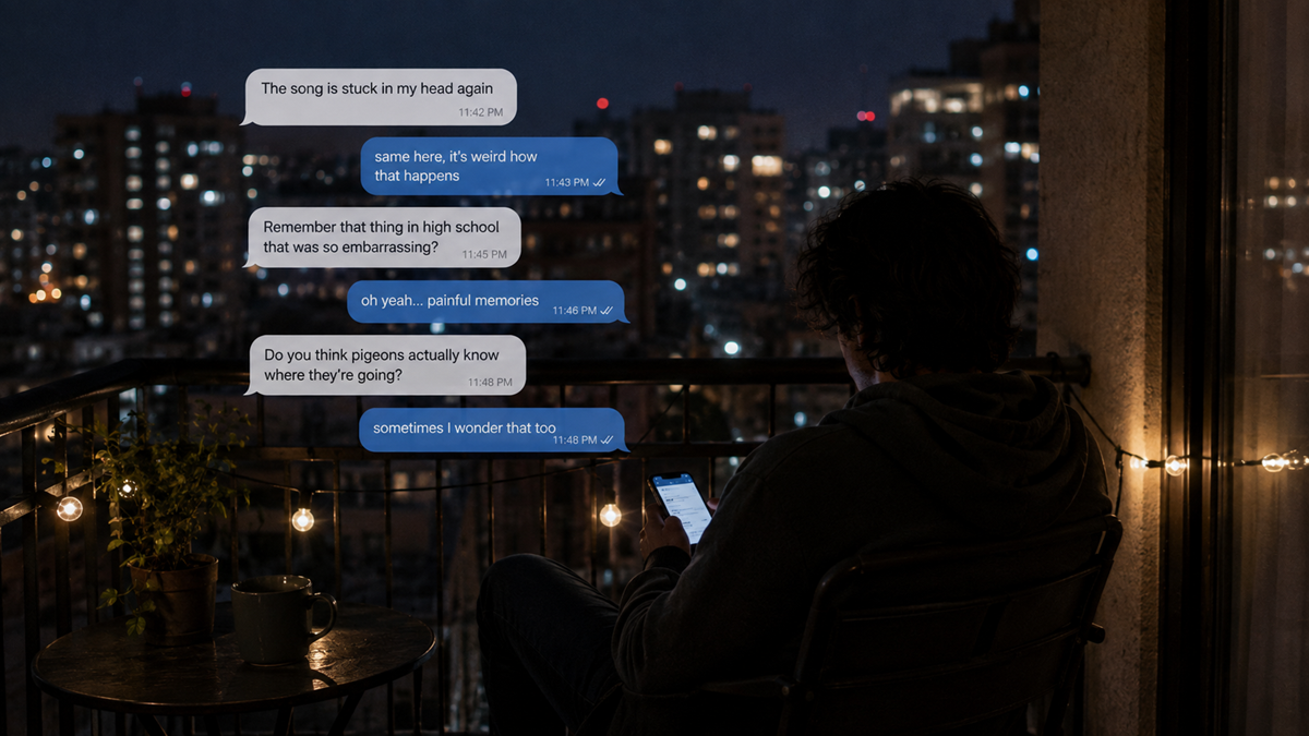 A person sits on a balcony at night, texting on their phone. City lights and string lights are visible. Text messages discuss a song stuck in their head, high school memories, and thoughts about birds’ destinations. Friends.