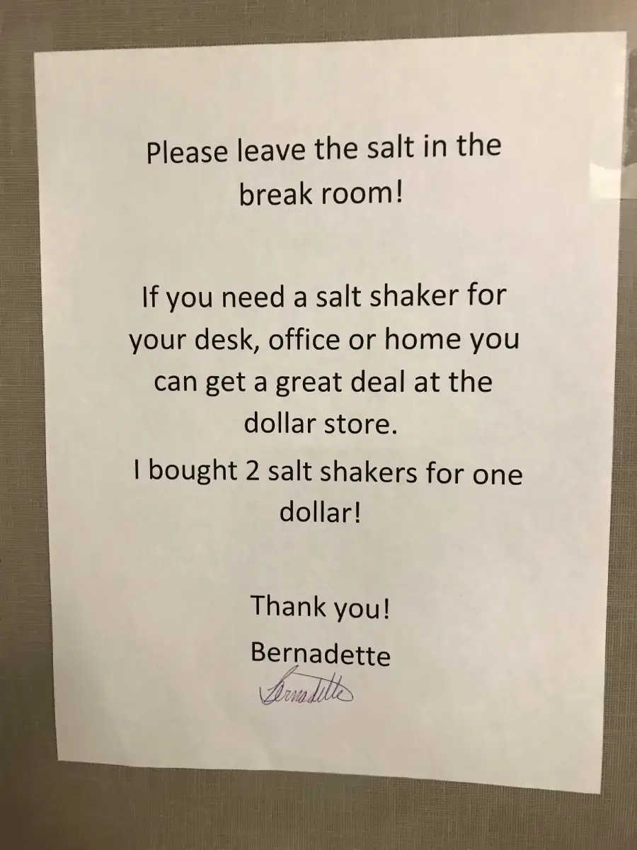 A printed sign asks people to leave the salt in the break room and suggests buying salt shakers at the dollar store, mentioning two were purchased for one dollar. It is signed “Thank you! Bernadette.”