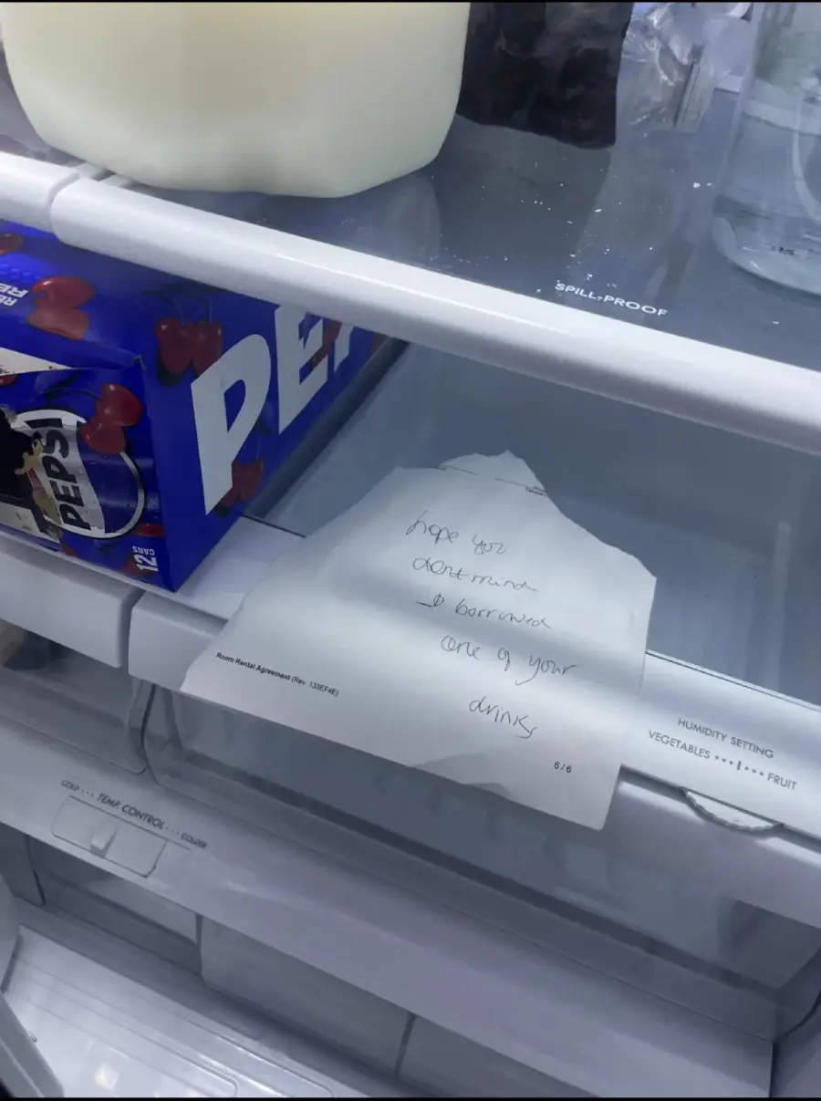 A fridge shelf holds a gallon of milk, a box of Pepsi cans, and a handwritten note that says, “Hope you don’t mind, I borrowed one of your drinks.”