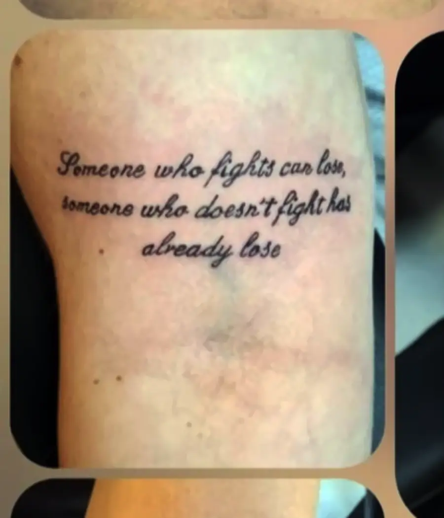 Tattoo with cursive text reads: “Someone who fights can lose, someone who doesn’t fight has already lose.” The final word appears to be a grammatical error; it should read “lost.”