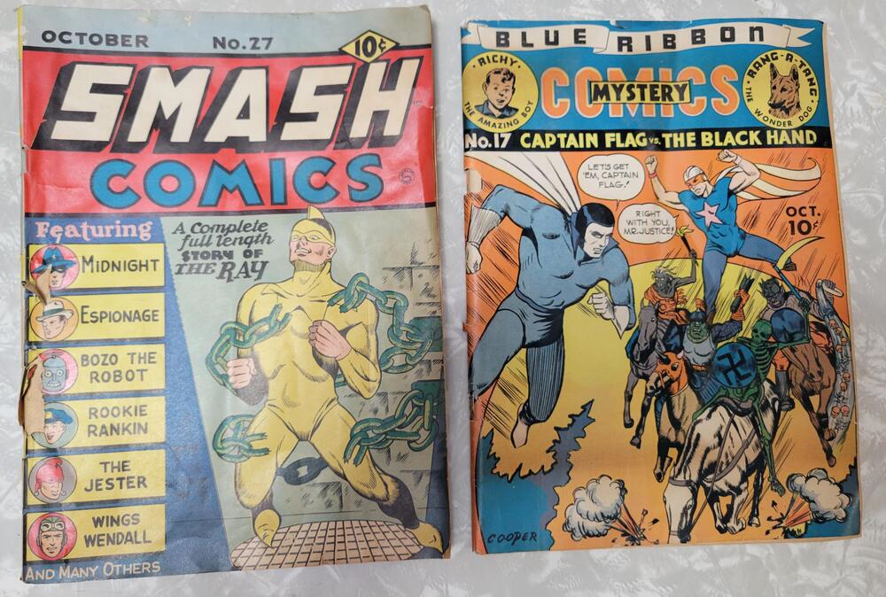 Two vintage comic books with colorful classic superhero artwork.
