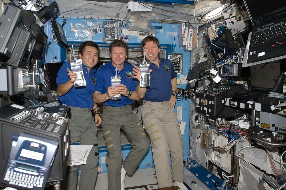 Astronauts drink water inside the International Space Station.