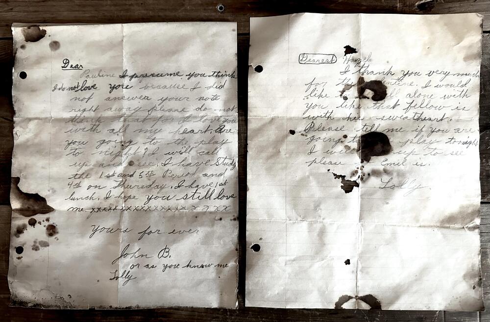 Two old, stained handwritten letters on crumpled paper.