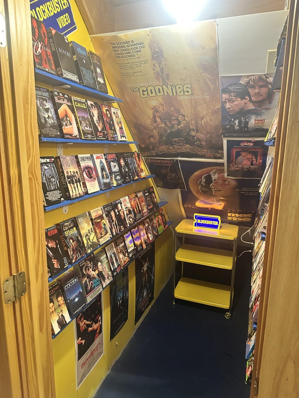 A room decorated like a retro video rental store.