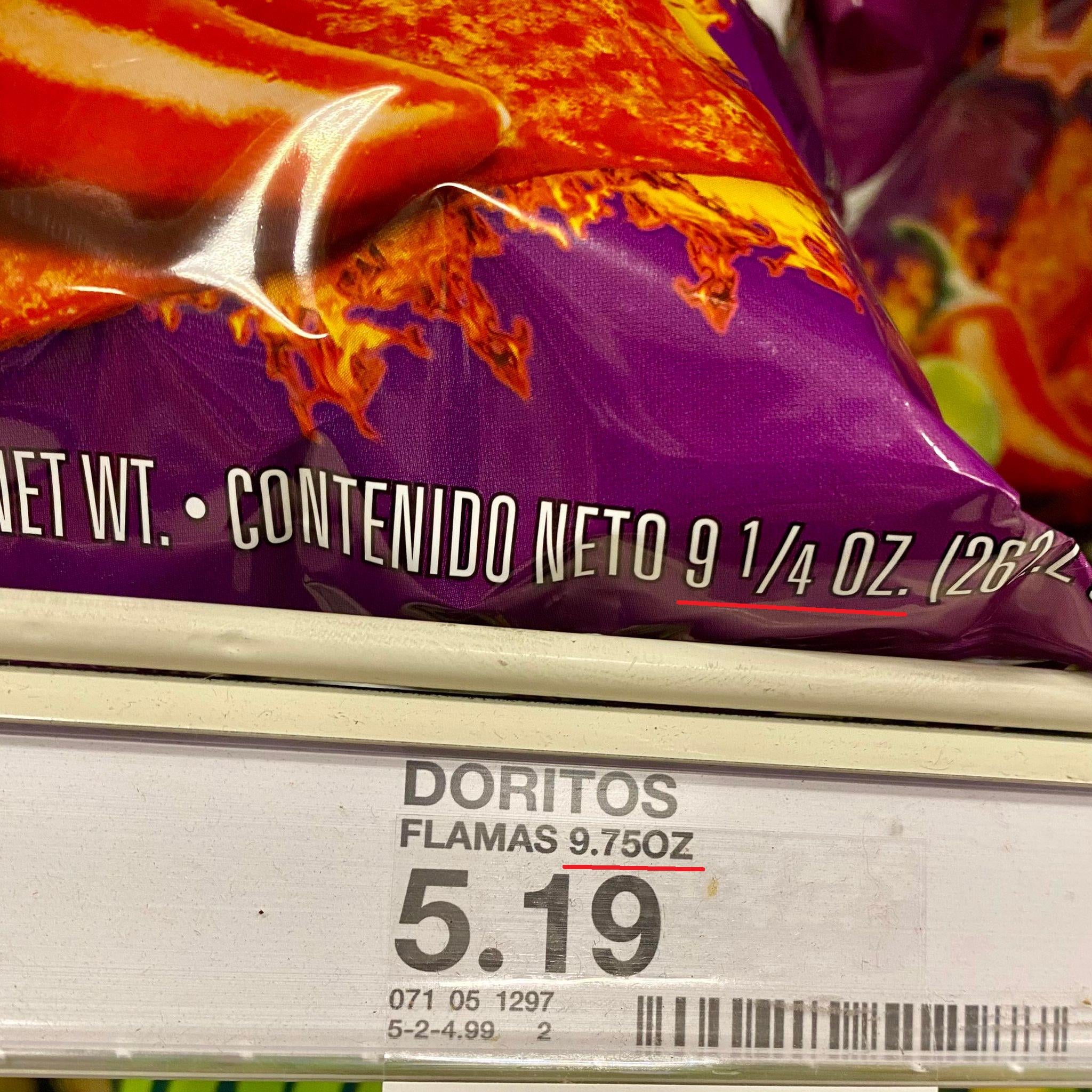 Close-up of a bag of Doritos Flamas chips on a store shelf, showing 9 1/4 oz.