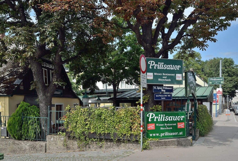 The exterior of a traditional restaurant and pub surrounded by trees.