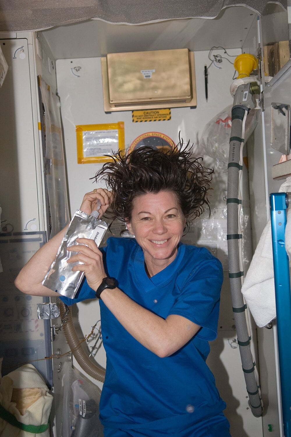 An astronaut washes her hair inside the International Space Station.