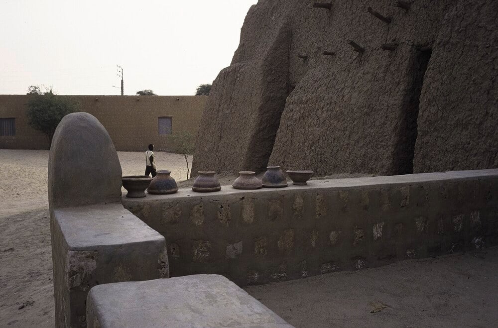 Mud-brick architecture and a sandy courtyard in Timbuktu, Mali.