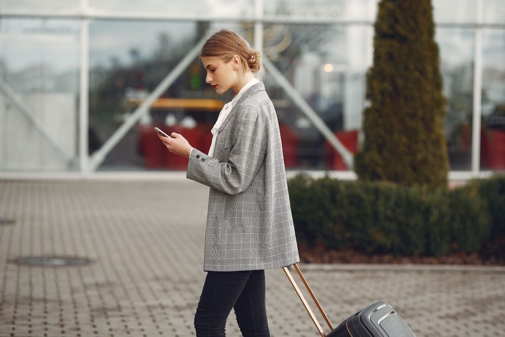 Traveler booking a trip on a phone