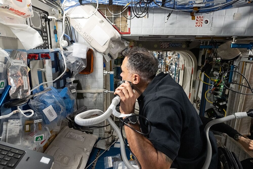 An astronaut shaves inside the International Space Station.