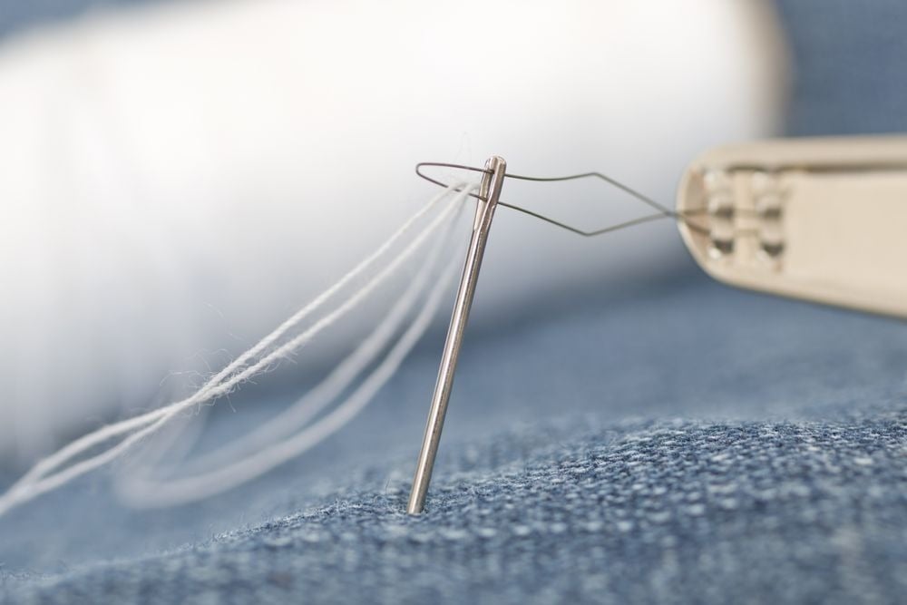 Mending clothes with a needle