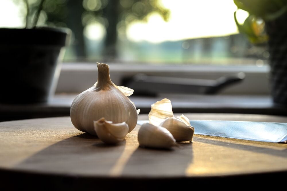 Garlic bulbs and cloves on a wooden table.