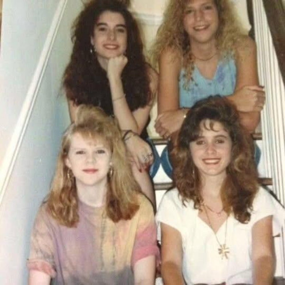Friends pose together in 80s-style fashion.