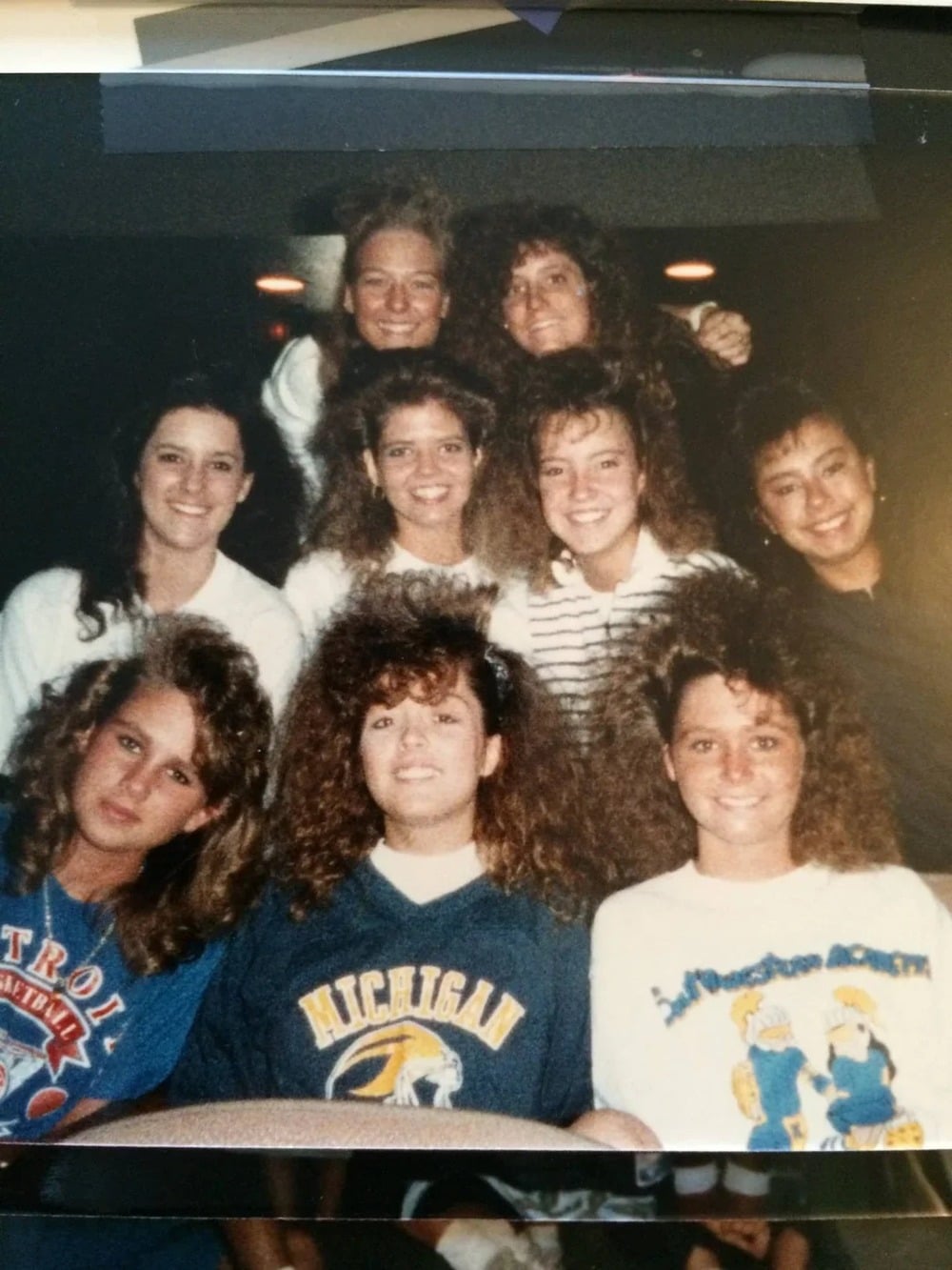 Young women pose with big 1980s-style hair.