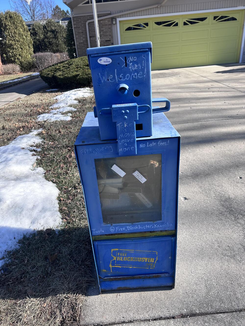A surviving video return box repurposed as a neighborhood lending library.