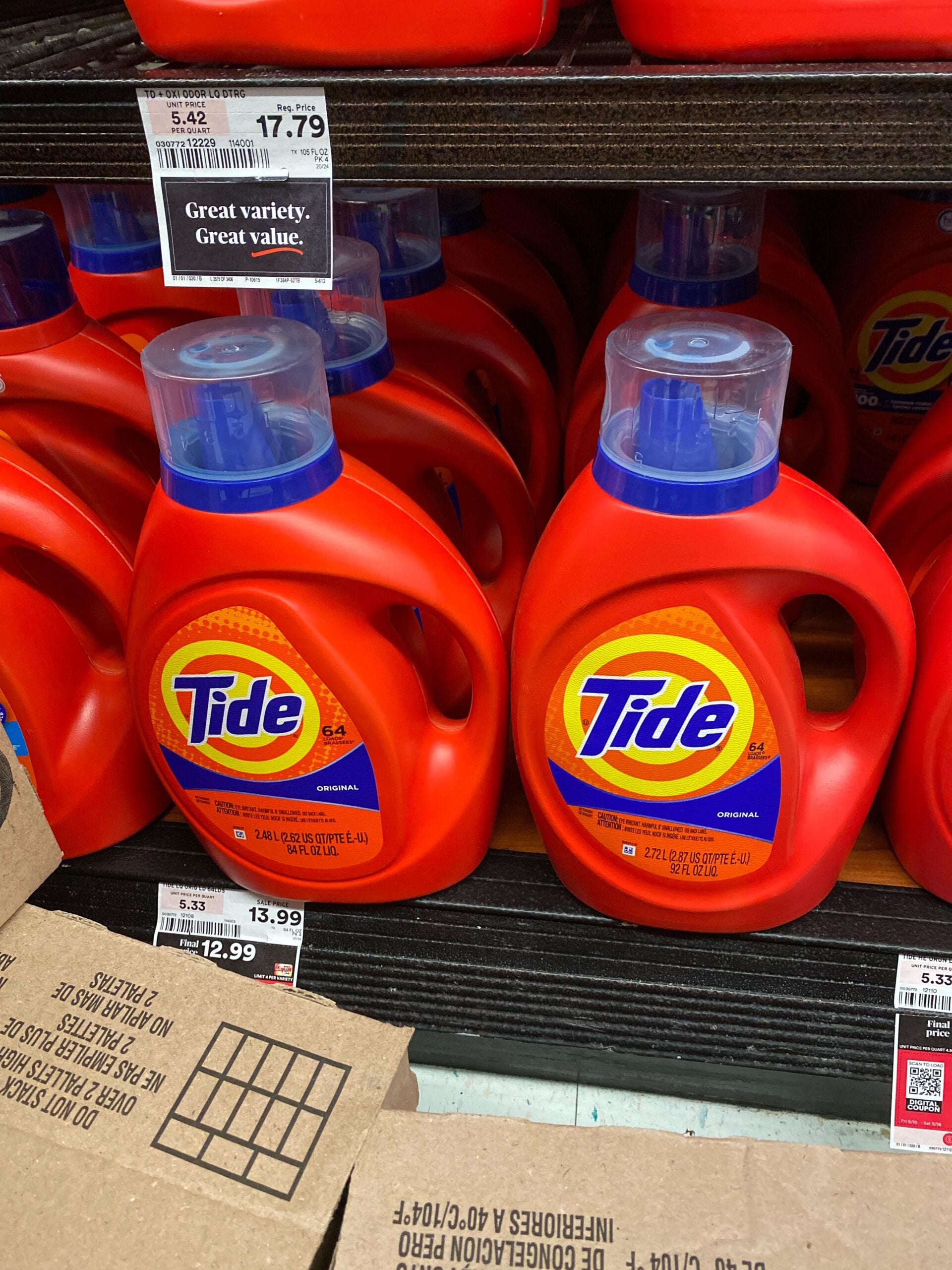 Large bottles of Tide liquid laundry detergent on a store shelf.