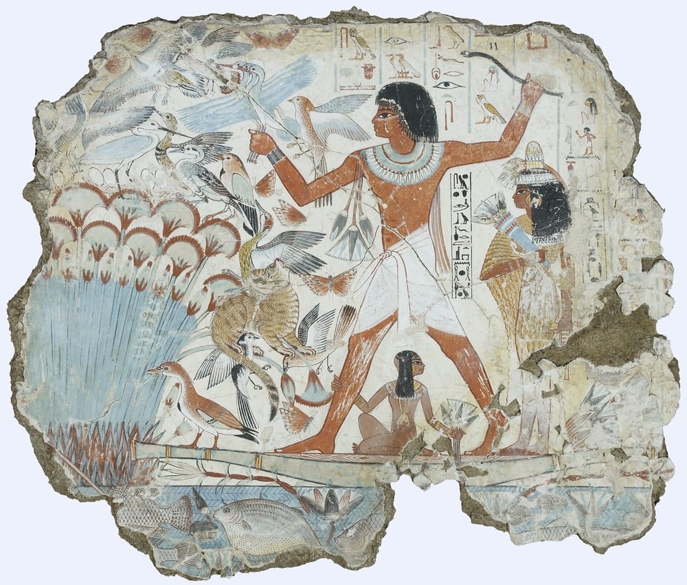 Ancient Egyptian wall painting shows a man standing on a boat hunting birds with a throw stick in a marsh, surrounded by reeds, birds, fish, and two smaller figures.