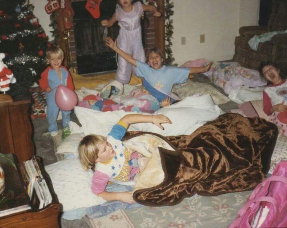 Children play at a sleepover in pajamas.