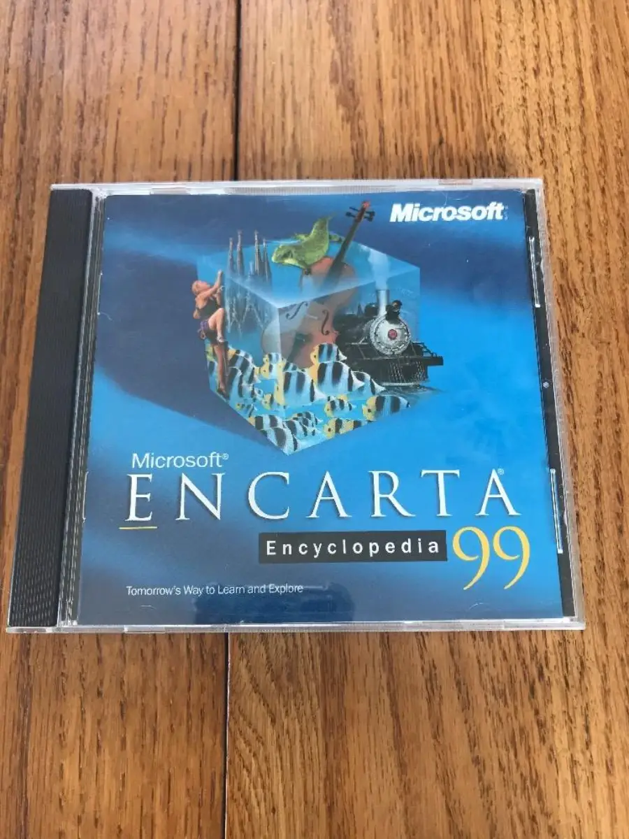 A Microsoft Encarta Encyclopedia 99 CD case on a wooden surface. The cover features various illustrations, including a violin, fish, and a ship, set against a blue background.