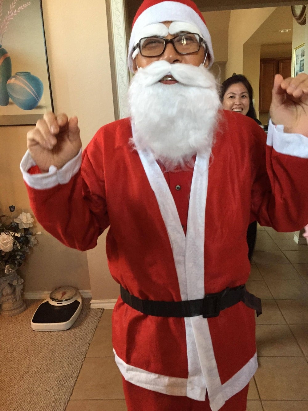 A person dressed as Santa Claus indoors.