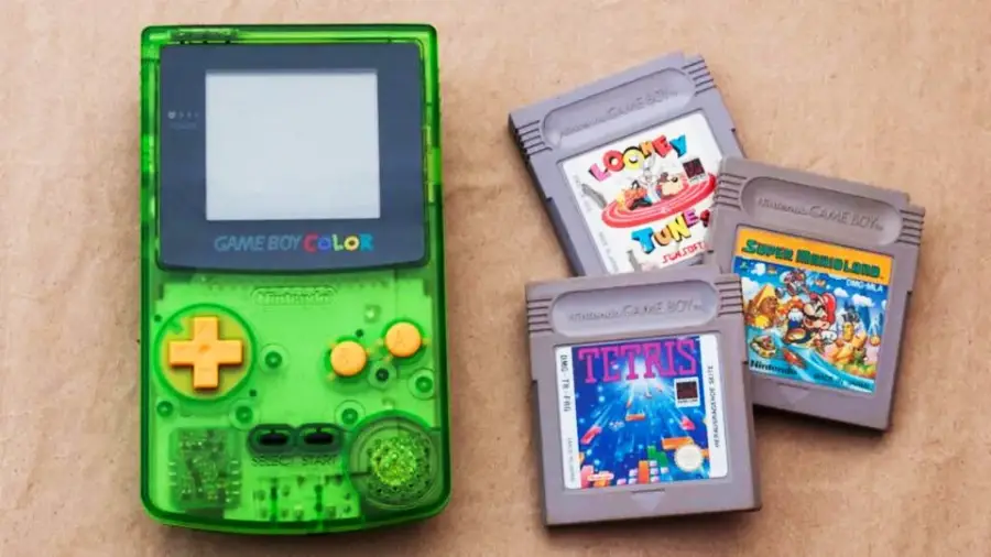 A green Game Boy Color is next to three game cartridges: Looney Tunes, Tetris, and Super Mario Land, on a brown background.