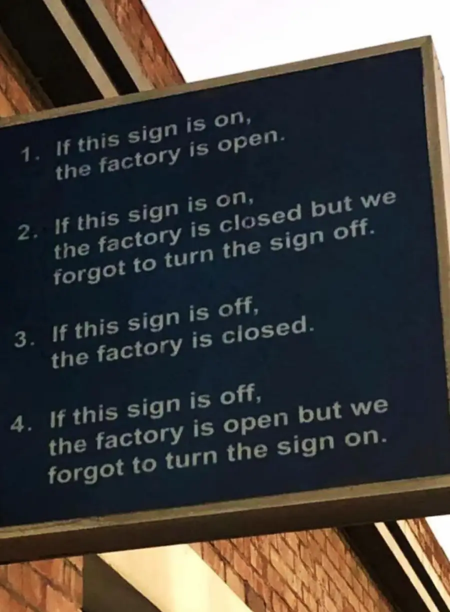 A blue sign humorously explains that whether the sign is on or off, the factory’s open or closed status may not match due to possible errors in turning the sign on or off.