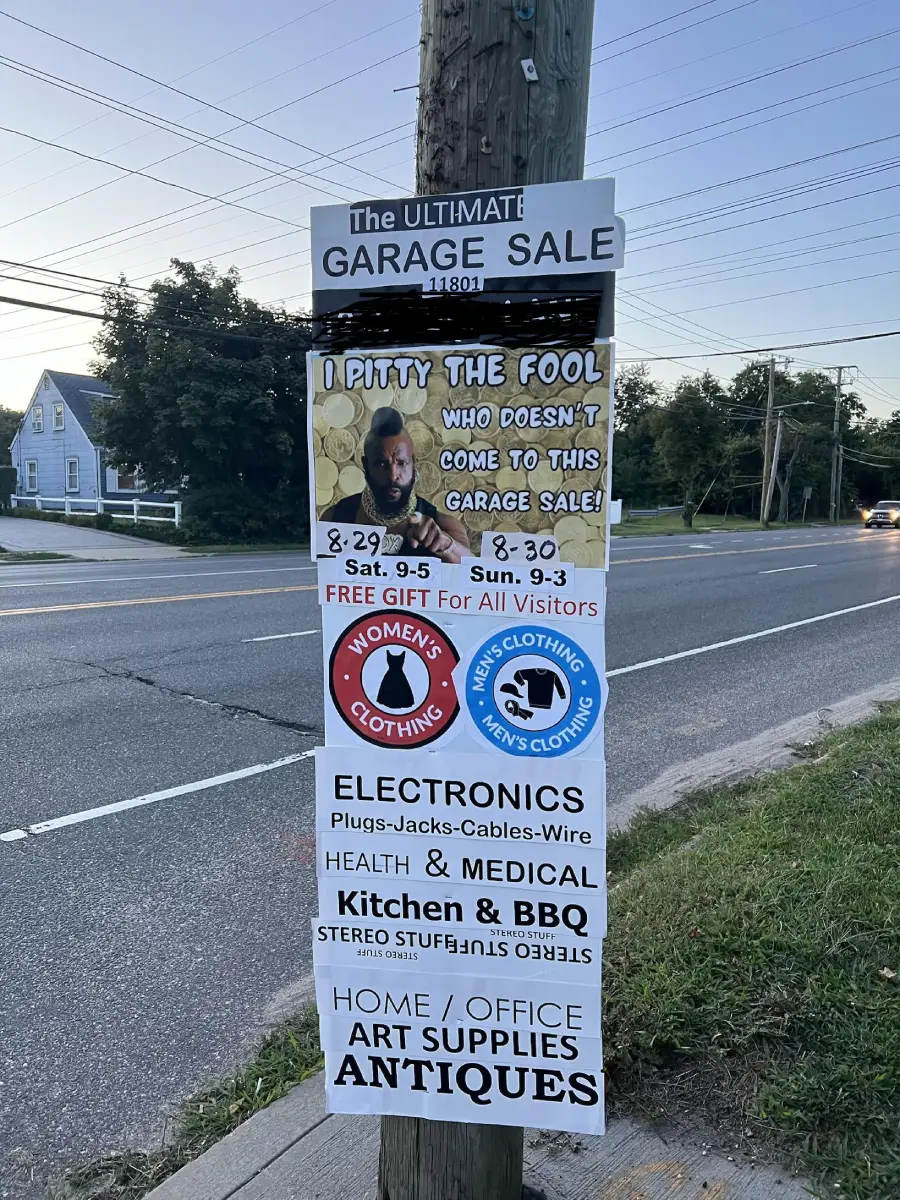 A garage sale sign on a utility pole lists dates, times, and categories like clothing, electronics, kitchen, and antiques. A Mr. T image says, “I pity the fool who doesn’t come to this garage sale!”