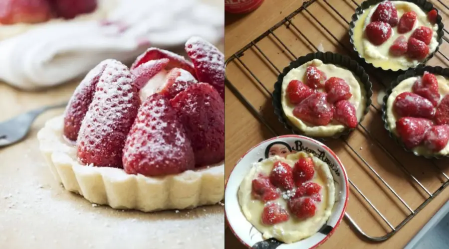 Close-up of a strawberry tart dusted with powdered sugar on the left; three smaller strawberry tarts cooling on a rack and a plate on the right.