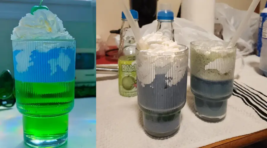 Two glasses of layered drinks, one bright green with whipped cream and two blue drinks with whipped cream on top, all served in ridged glasses. Bottles and kitchen items are visible in the background.