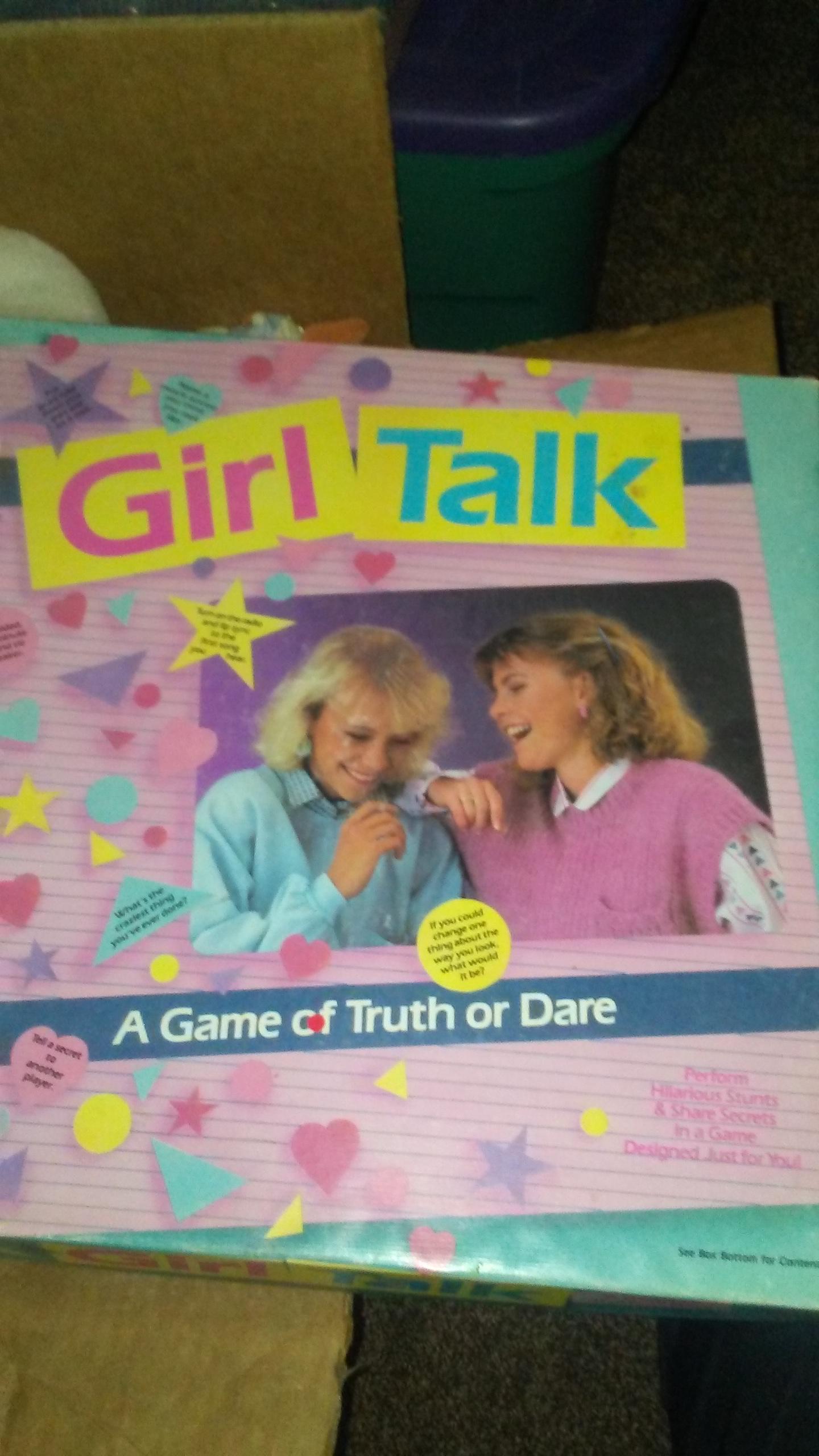 Box for “Girl Talk: A Game of Truth or Dare,” featuring two girls laughing together, with a pink and purple background decorated with stars and hearts.