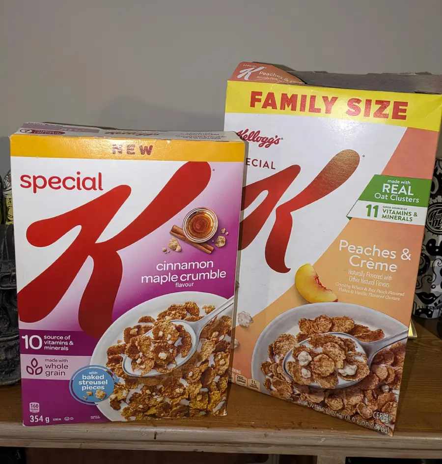 Two boxes of Special K cereal are side by side. One is a cinnamon maple crumble flavor, and the other is a family size peaches & crème flavor. Both feature images of cereal in bowls on the front.