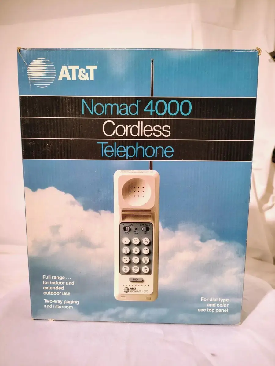 AT&T Nomad 4000 Cordless Telephone box with a photo of the phone against a cloudy sky background. Text highlights its features, including two-way paging and intercom.