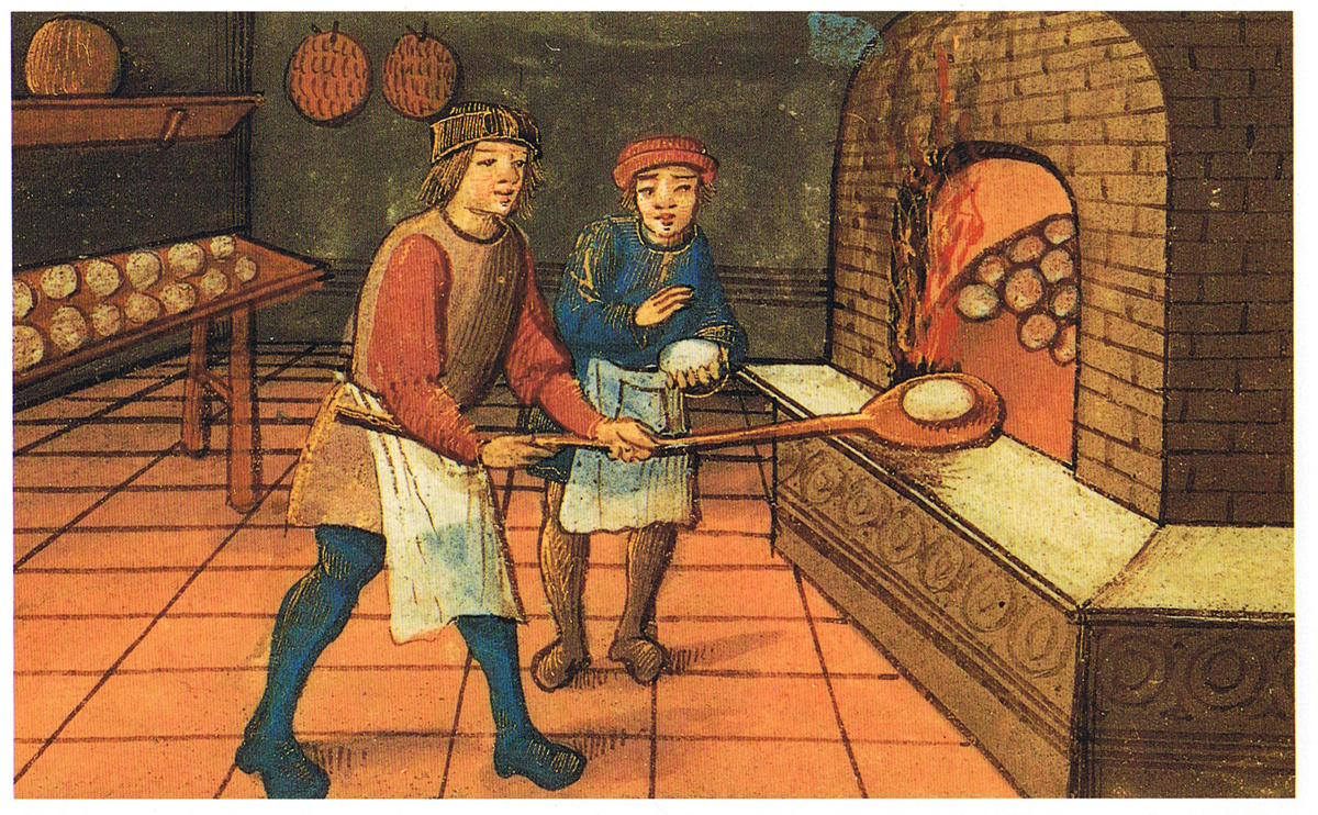 Two medieval bakers, one placing bread into a brick oven with a wooden peel, the other watching. Shelves with round loaves line the wall. The scene is indoors with tiled floors and hanging bread decorations.