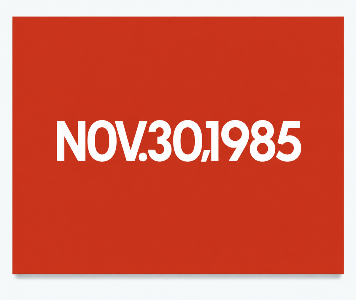 White text “NOV.30,1985” centered on a solid red background.
