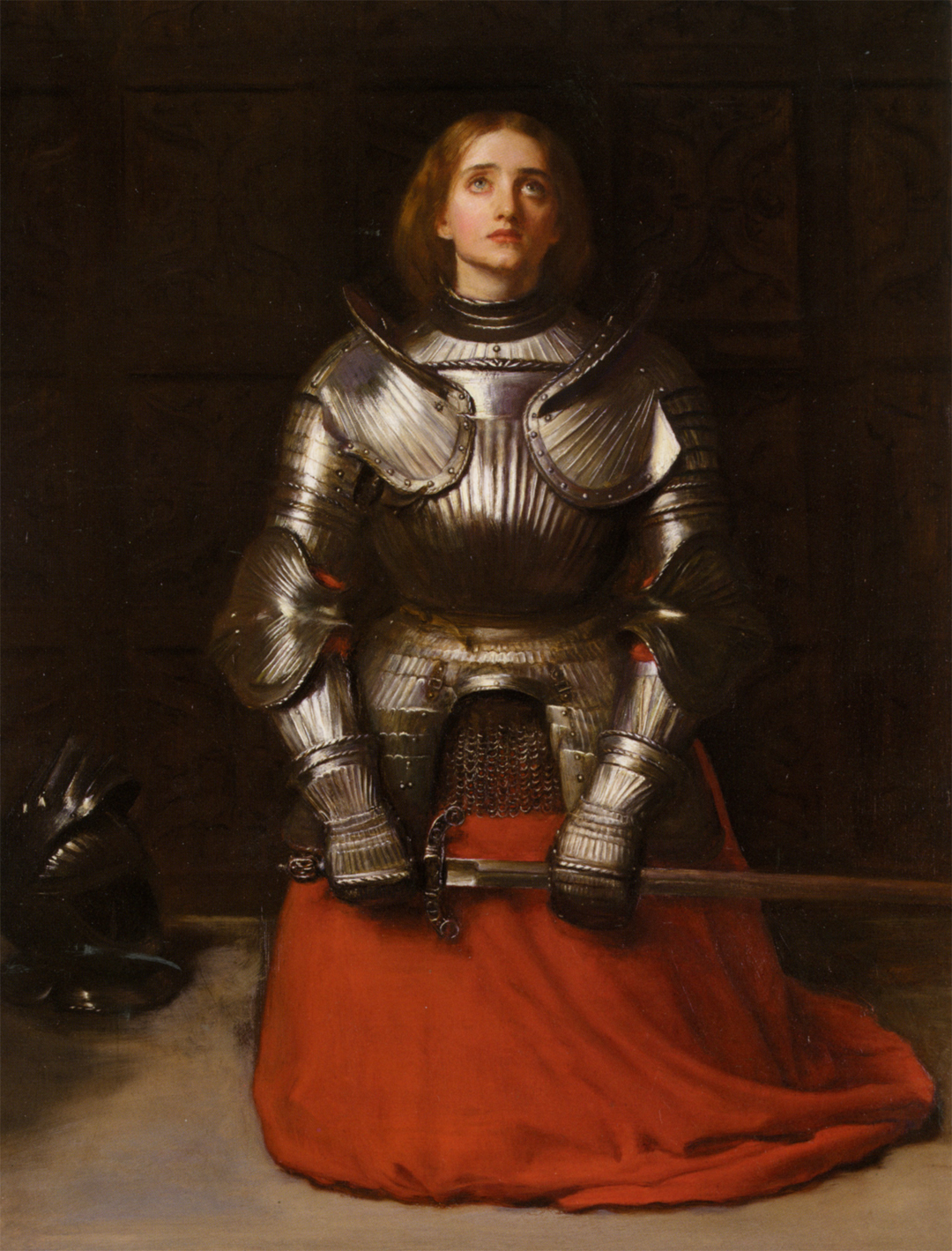 Historical figures. A person in shining armor kneels with hands on a sword, red fabric spread out, looking upward. A helmet sits on the floor beside them.