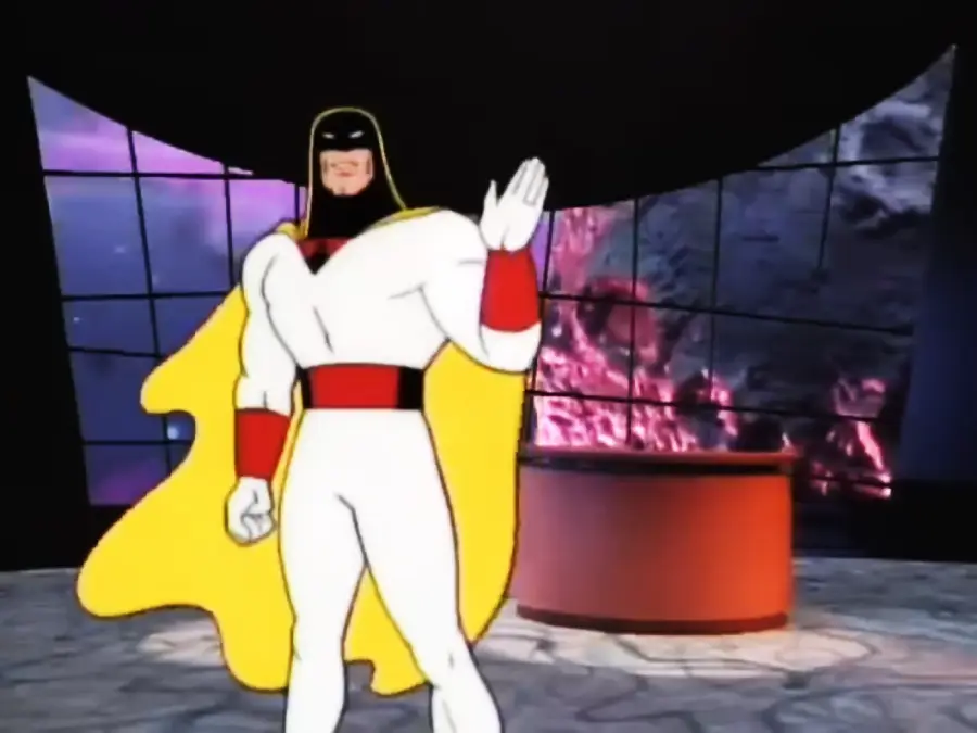 Animated superhero in a white suit and yellow cape stands waving in a futuristic studio setting with a large window showing a purplish cosmic background and a red desk nearby.