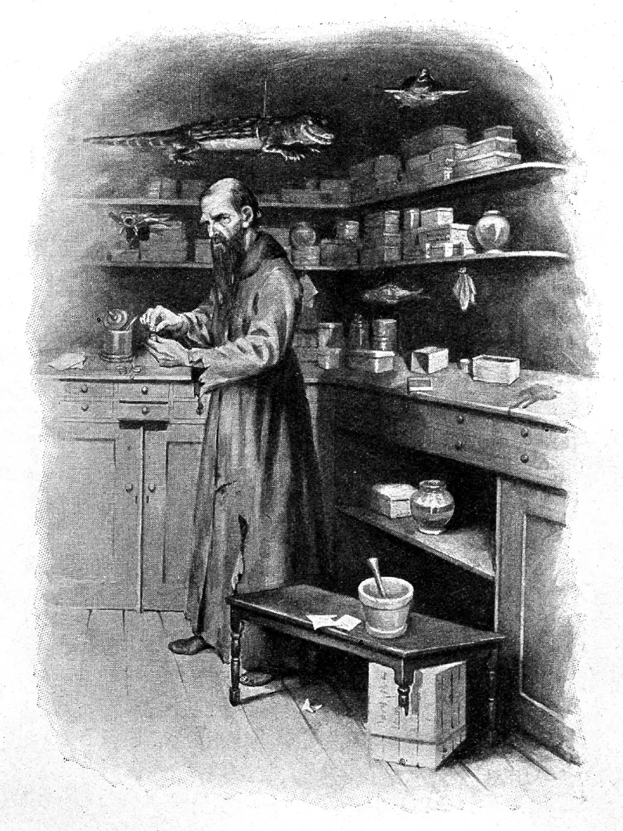 A bearded man in a robe stands in a cluttered room with shelves of jars, boxes, and animal specimens, holding a small object and working at a counter.
